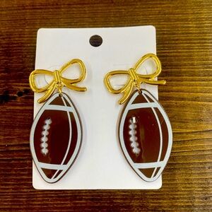New, very light football bow dangle earrings